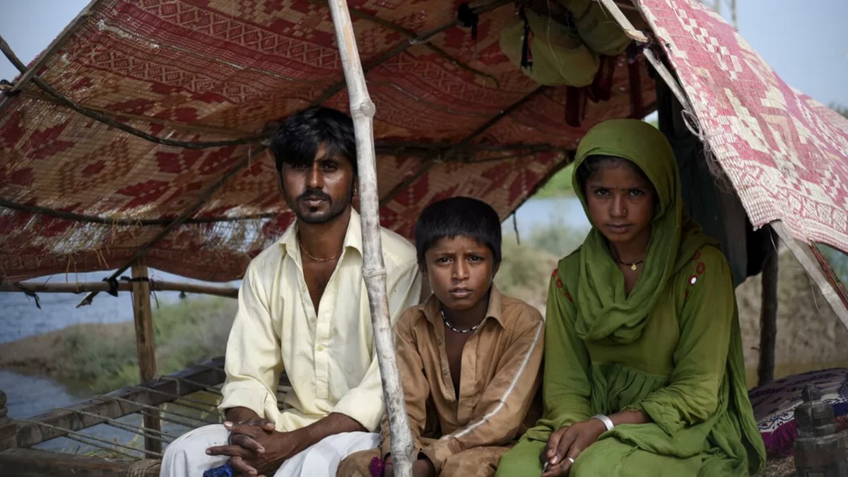 Young family in Pakistan living in a makeshift shelter