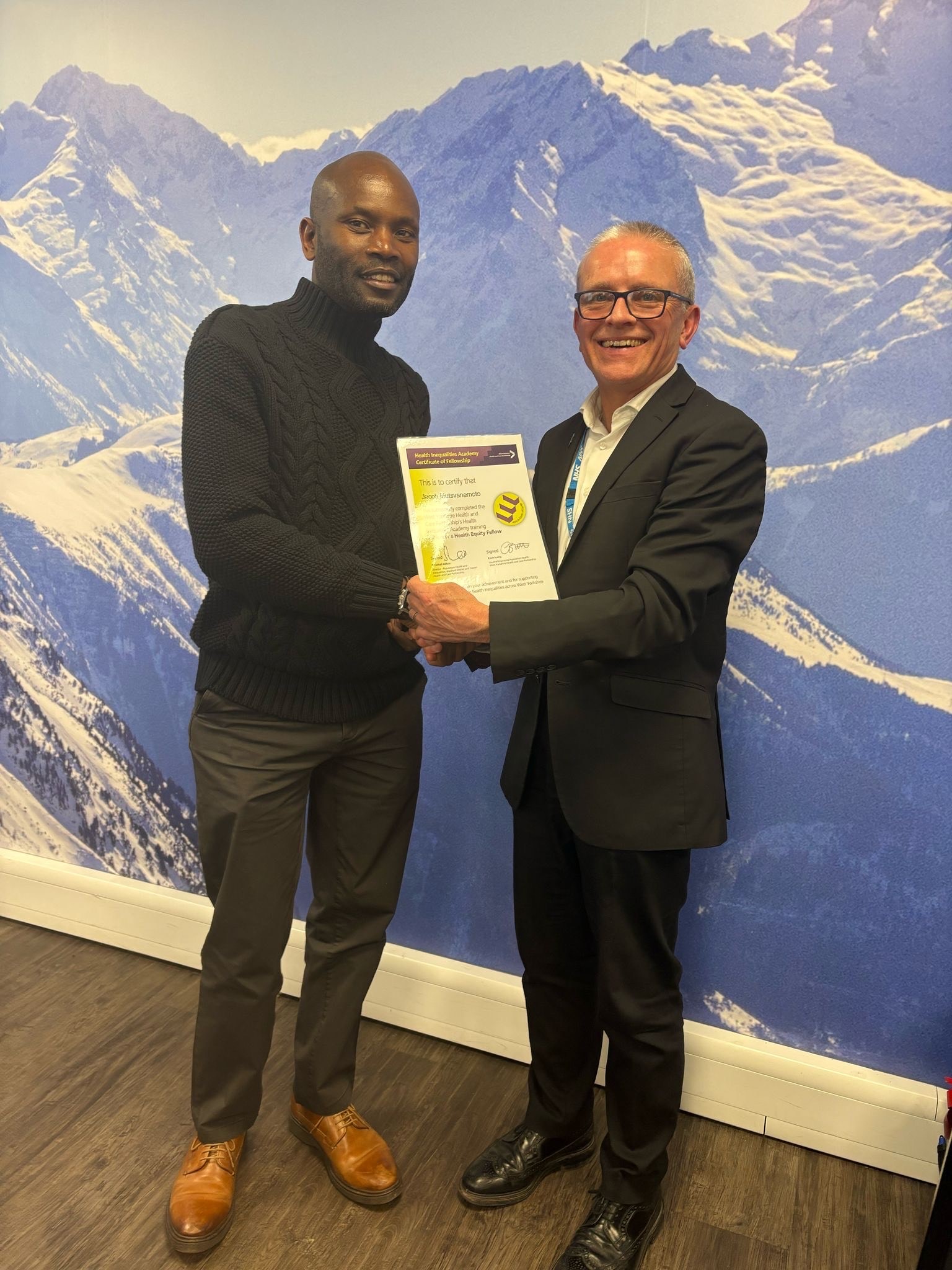 Left to right: Fellow Jacob Mutsvanemoto receiving his certificate from Robin Tuddenham, Chief Executive - Calderdale Council  Place Lead, Calderdale – NHS West Yorkshire Integrated Care Board 