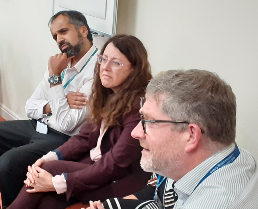 colleagues listening to a speaker off camera