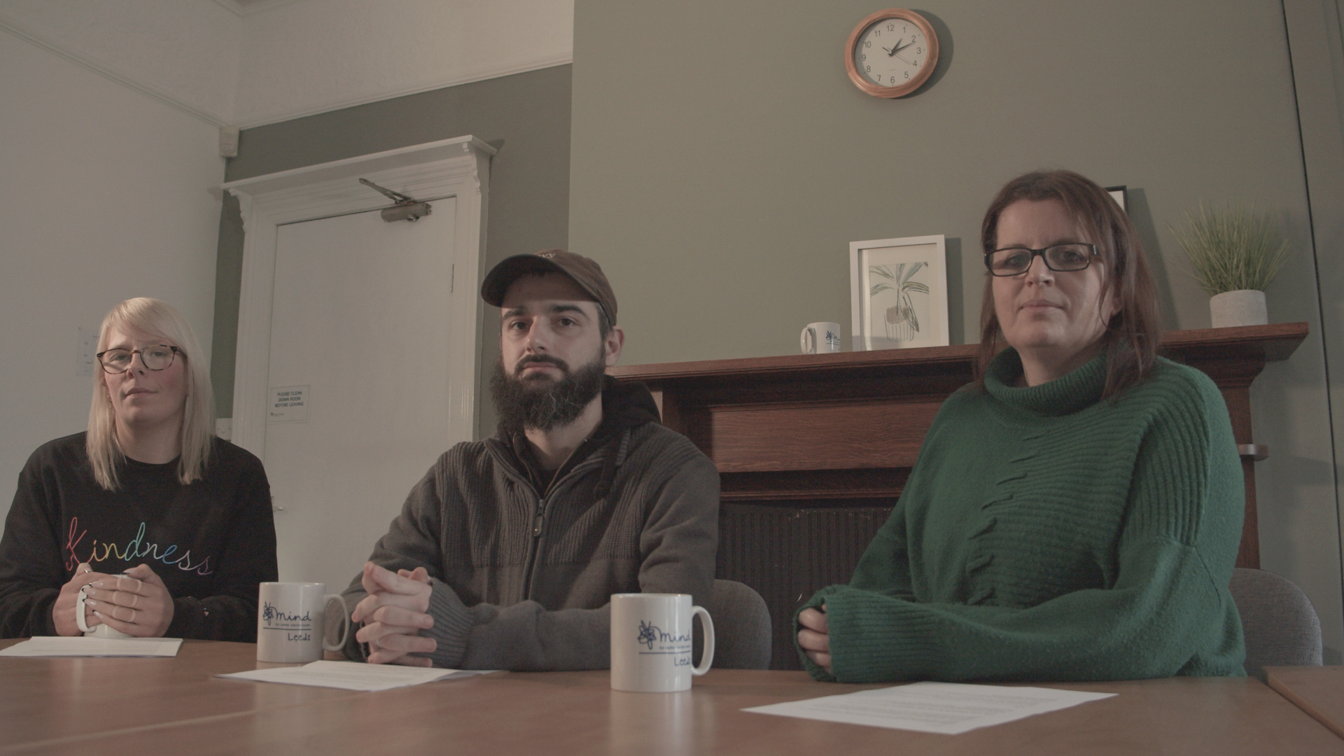 Some of the volunteers, pictured around a table, during the making of their film. jpg