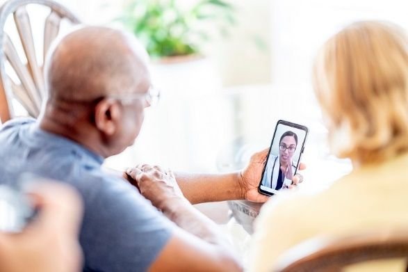 Man using smartphone for GP consultation [stock image]