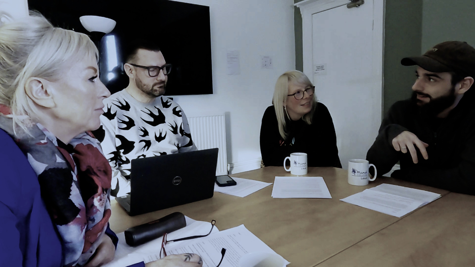 Image shows volunteers taking part in discussion around a table.jpg