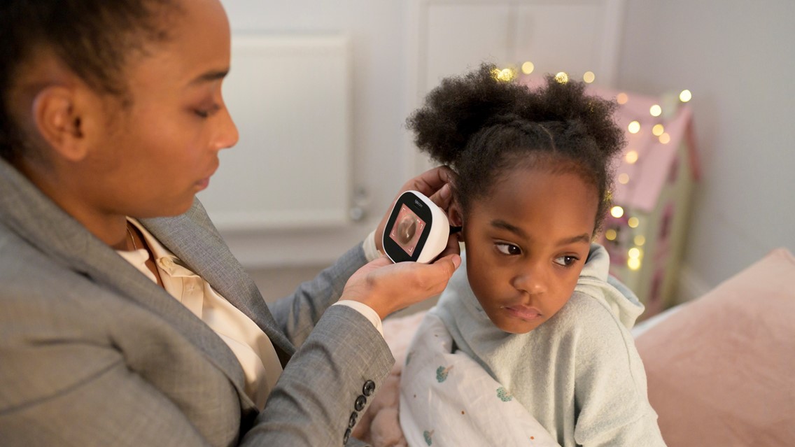 Tyto care device being used by a mum to help her daughter