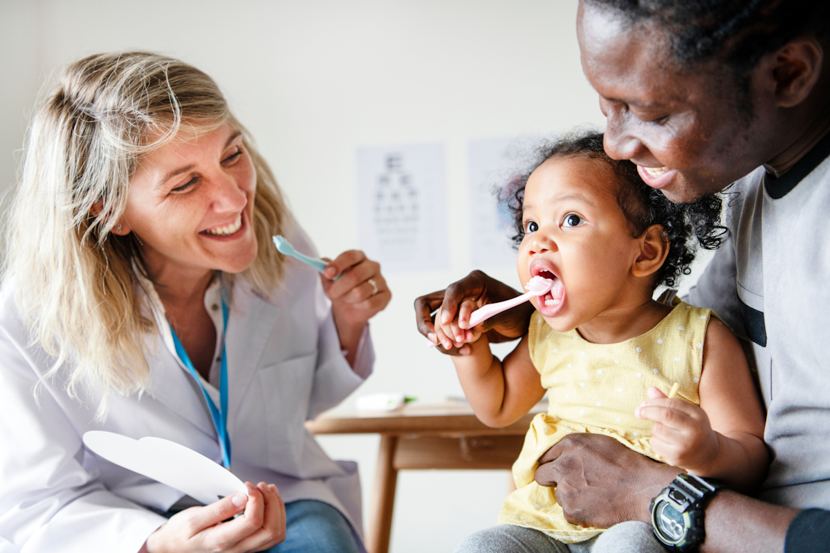 How to clean teeth - young child and parent with dentist