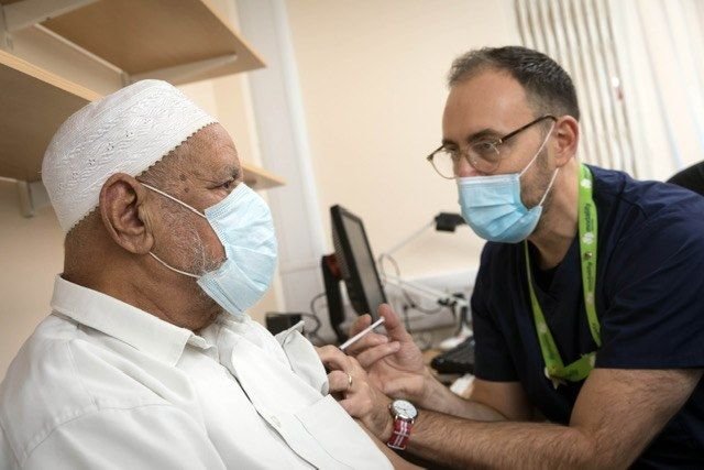 Dr James Thomas and patient wearing facemasks