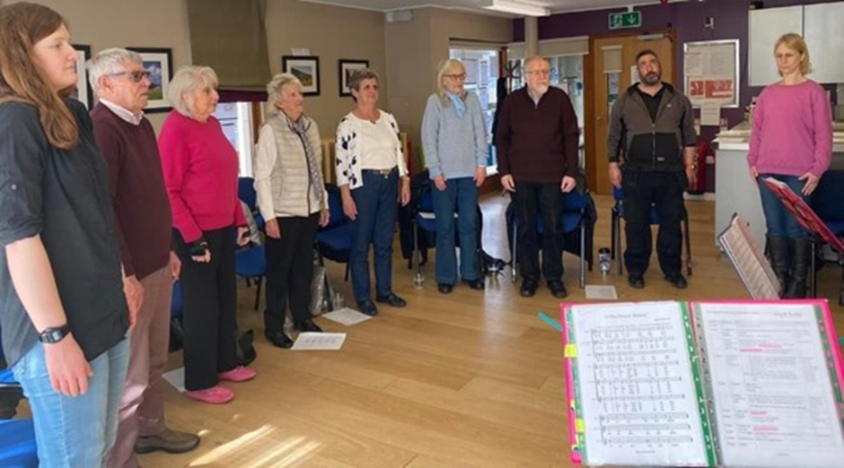 Image of people stood singing