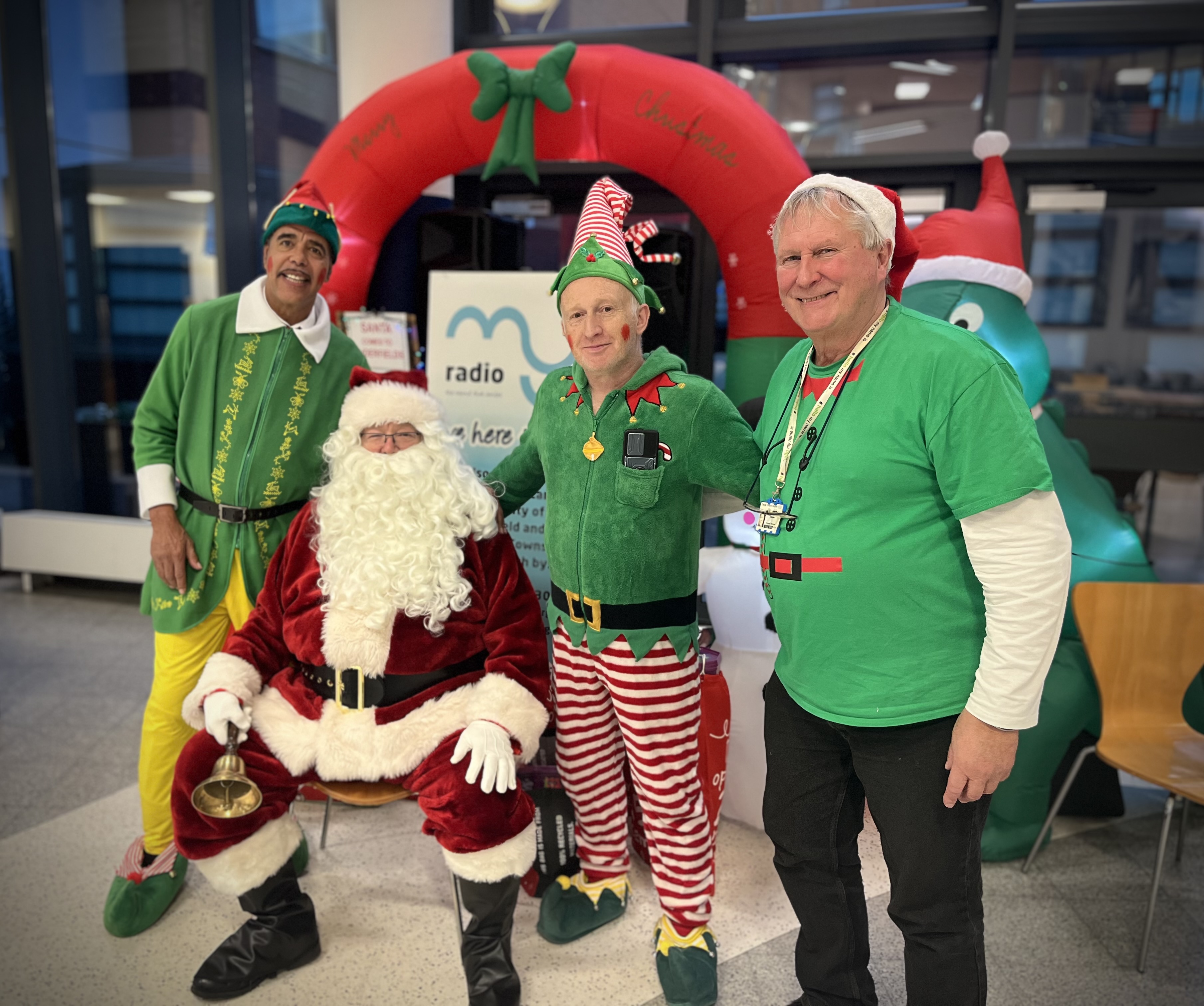 Chris Kamara dressed as a Christmas elf, with Pinerfields staff