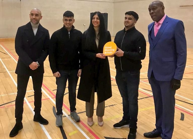 Young in Covid project team with their GMB award, presented by Frank Bruno