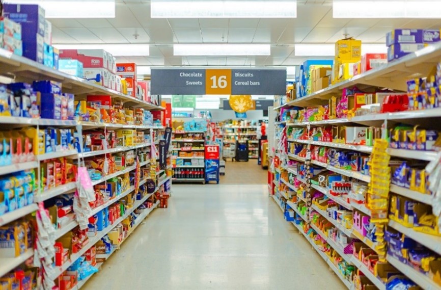 Supermarket shelves with ultra processed foods