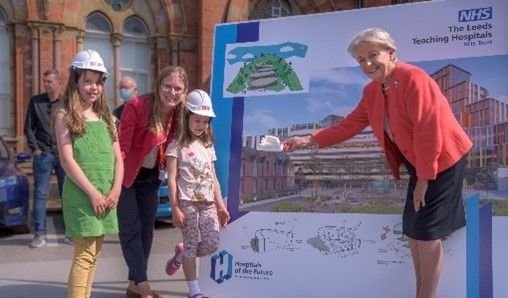 Dame Linda Pollard with Vicky Casey and daughters outside a Leeds hospital building