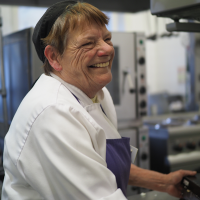 Kitchen worker smiling Photo credit: Credit Cellar Trust Bradford