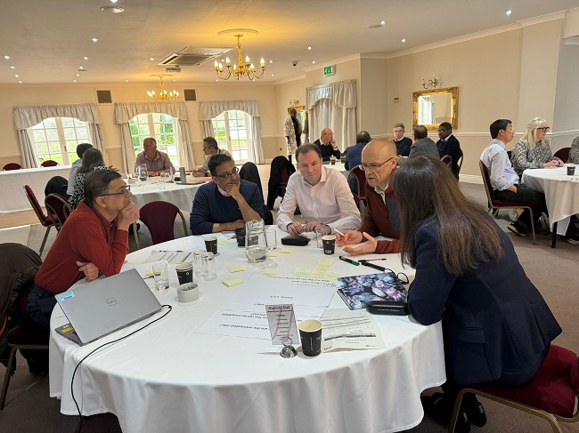 WYAAT colleages in conversation around the tables