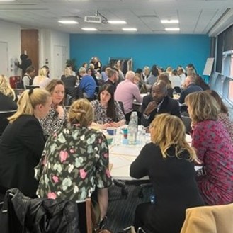 Living with obesity attendees sat at tables.jpg