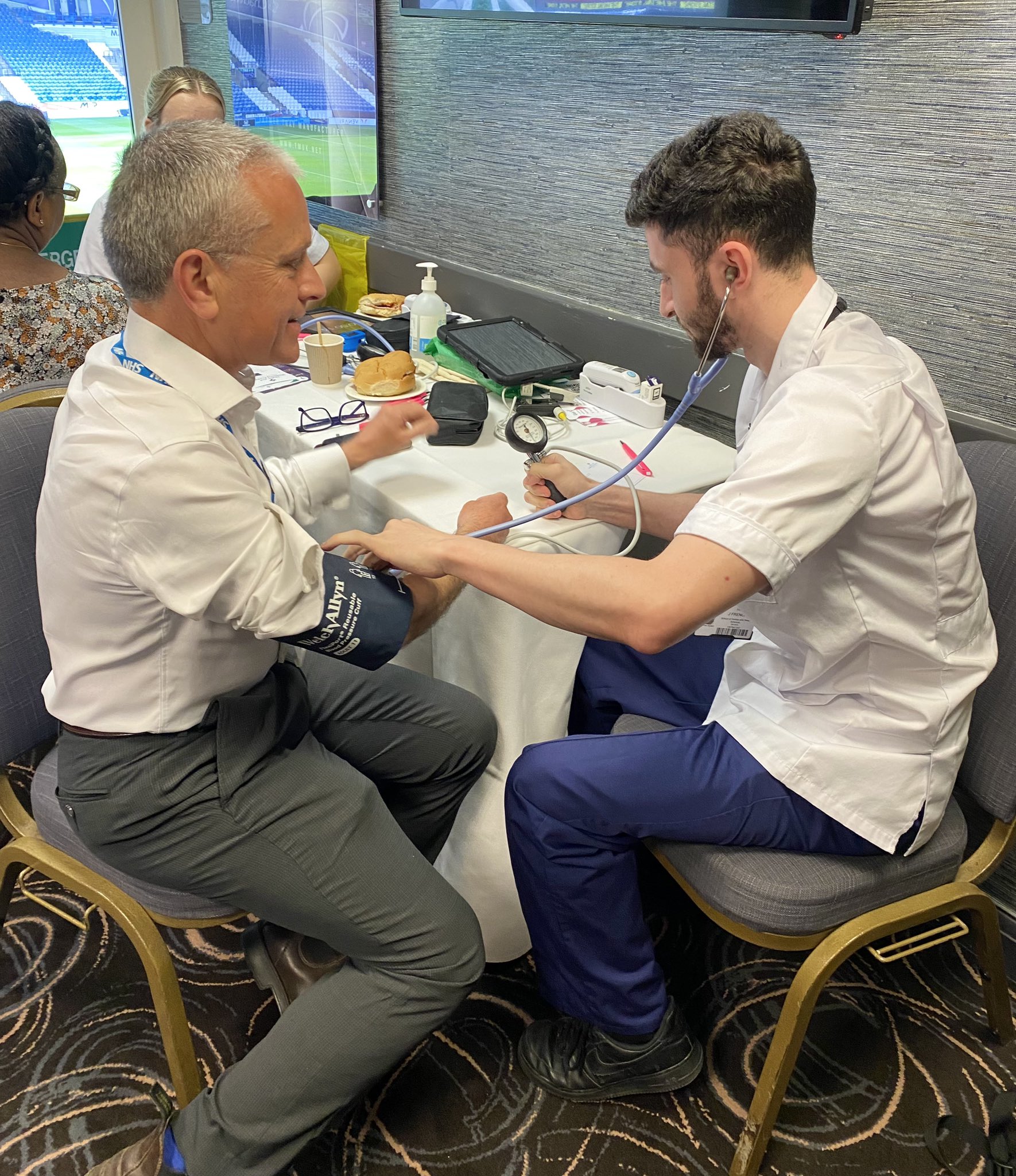 Man having blood pressure checked by a healthcare professional