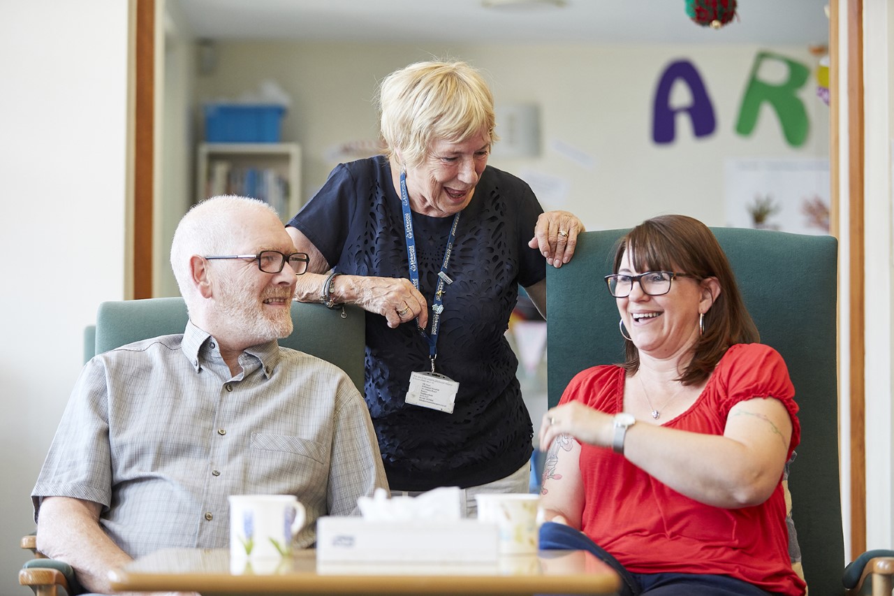 Hospice staff and residents chatting and laughing together