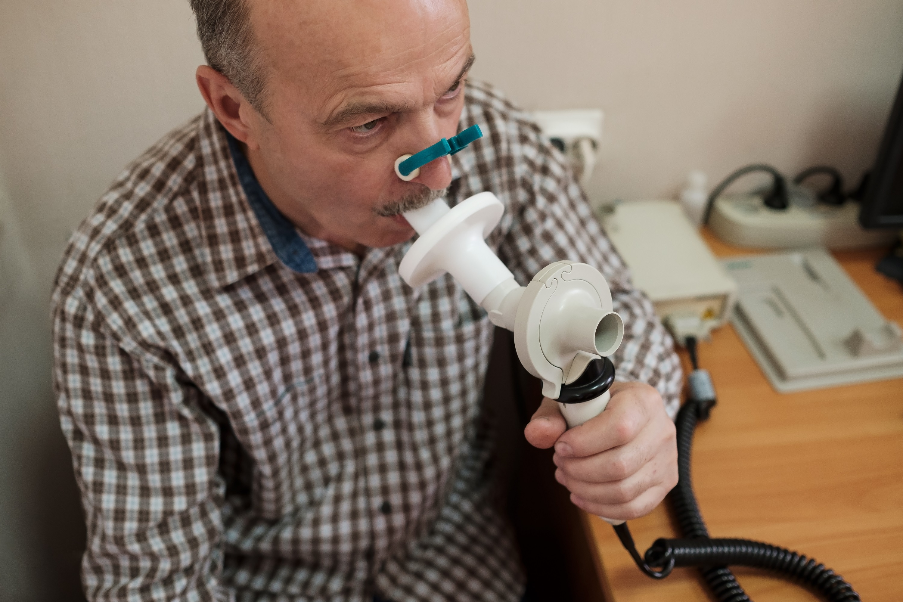 Older man taking a spirometry test