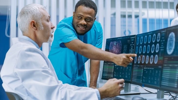 Man pointing to data on computer screen [stock image]