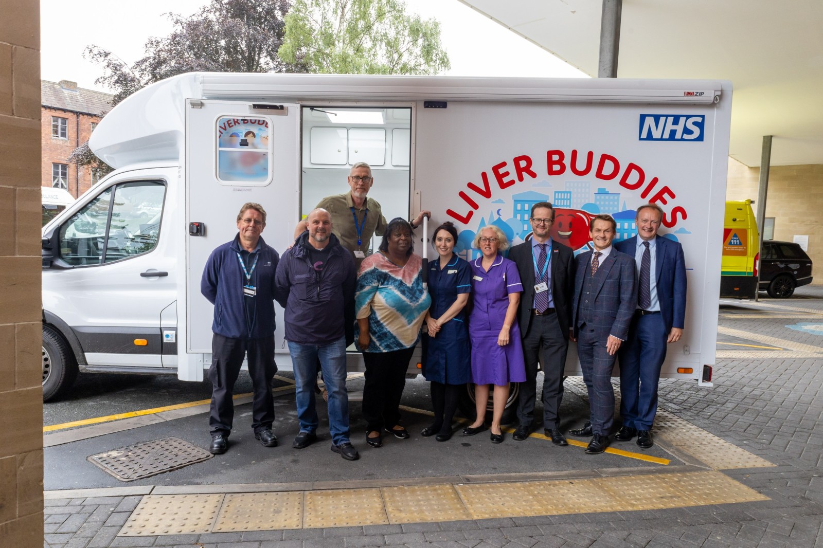 Liver buddies clinical team outside the mobile liver cancer screening unit nicknamed o-liver