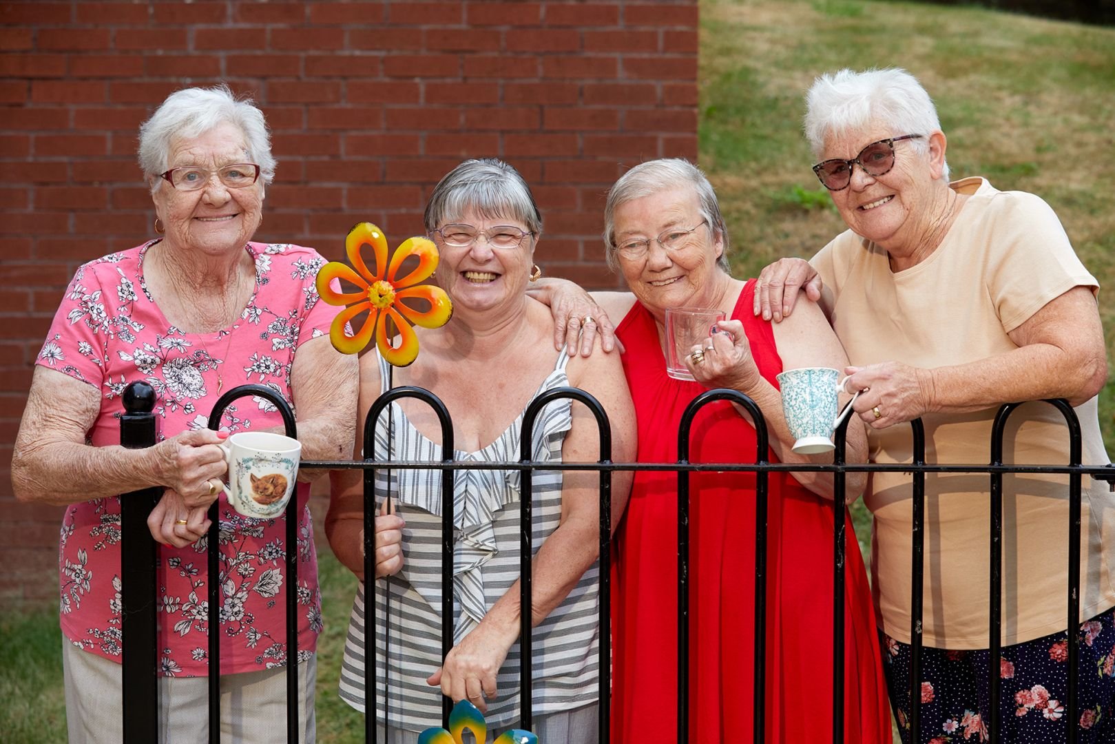 Four older women outside their housing in Wakefield