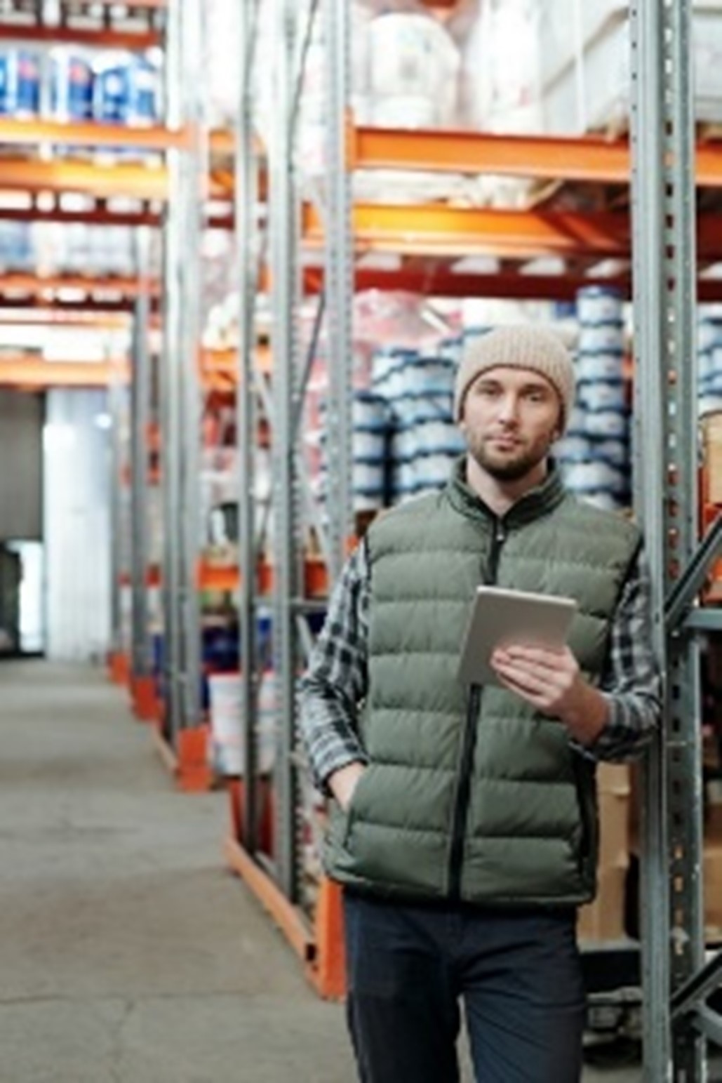 Man standing in a warehouse, not smoking