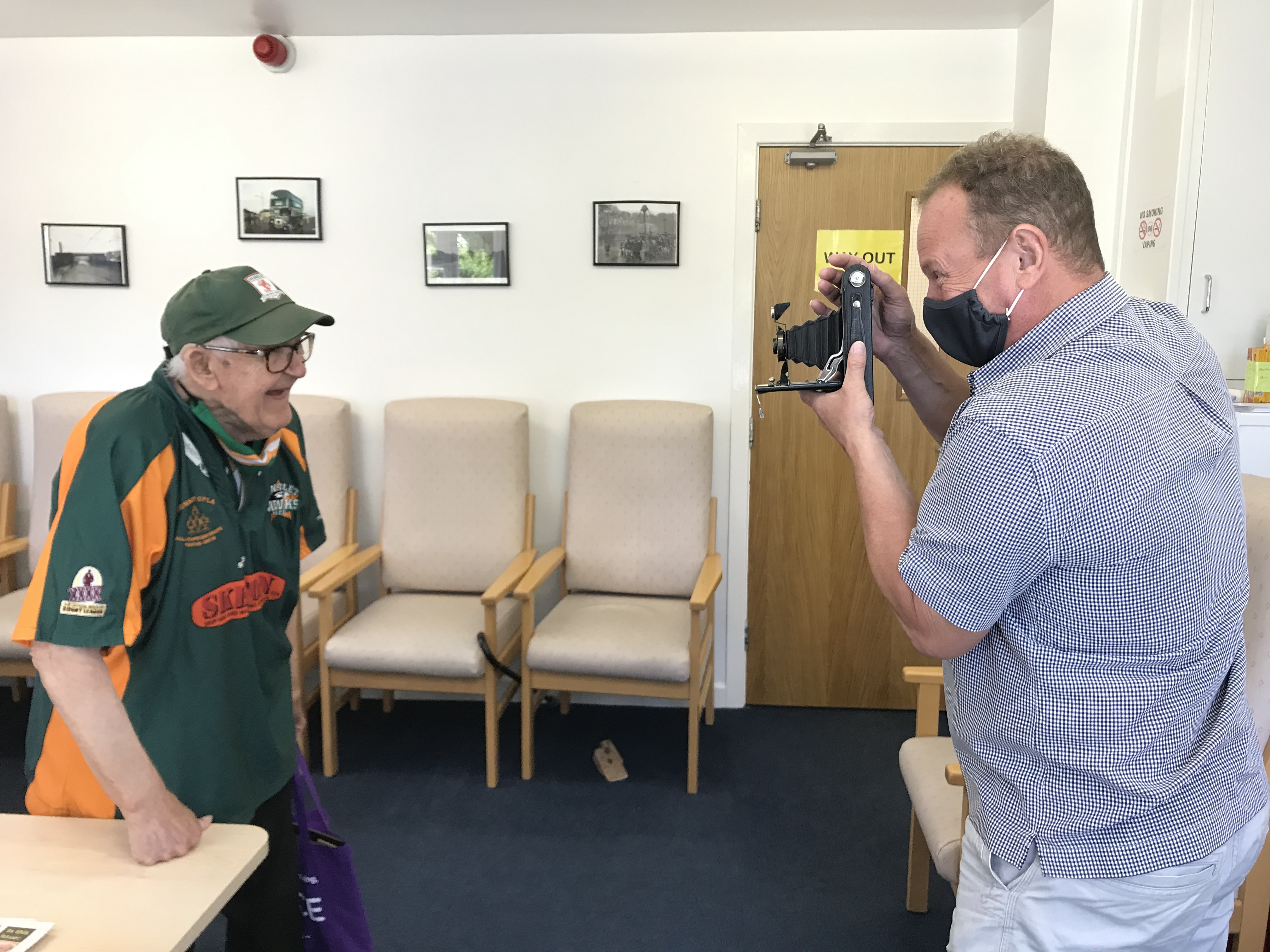 Lippy People - older man having his photograph taken with a vintage camera