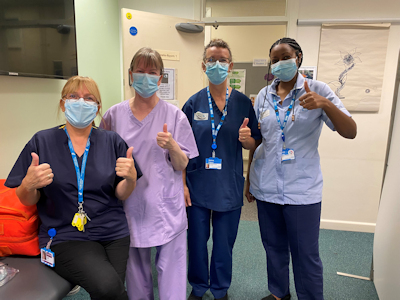 Calderdale and Huddersfield NHS Trust colleagues, masked, giving the thumbs up sign