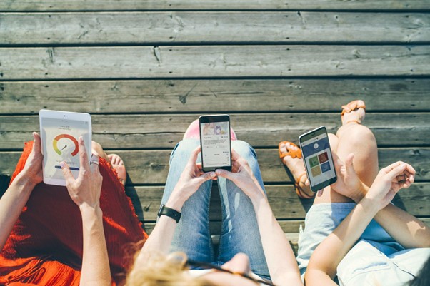 Three people with phones 