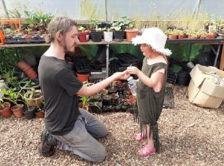 Big Lunch volunteers in the greenhouse