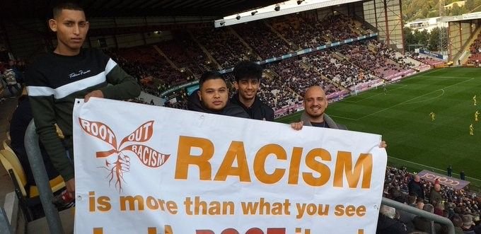 Bradford City fans display the Root Out Racism banner at Valley Parade
