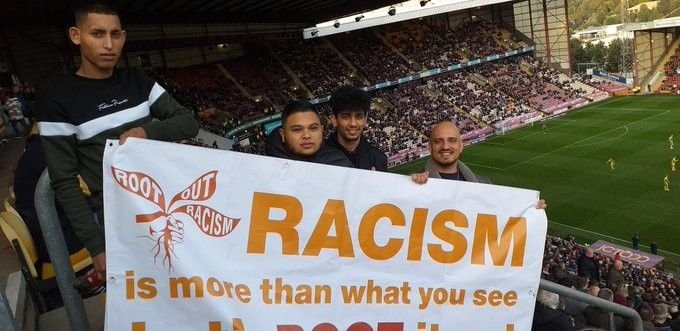 Bradford City fans display the Root Out Racism banner at Valley Parade