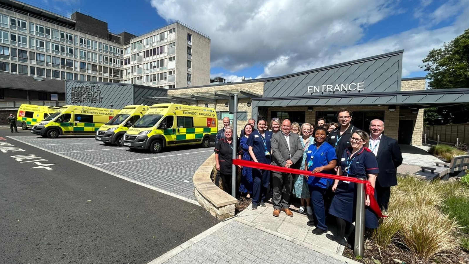 People smiling outside Huddersfield Royal Infirmary 