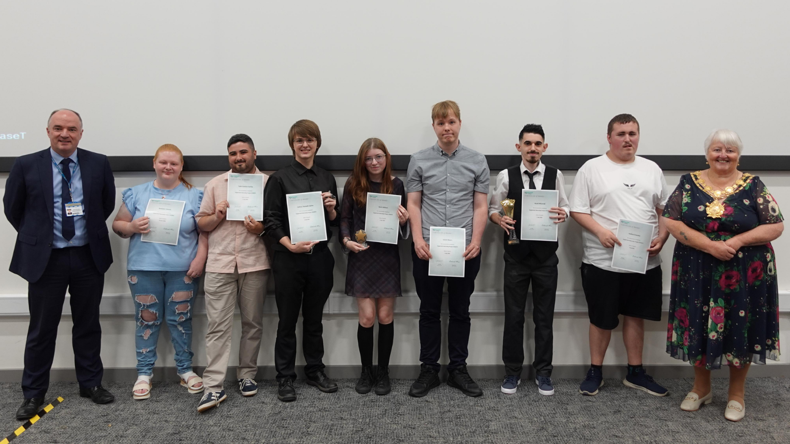 Image of group of people smiling holding certificates