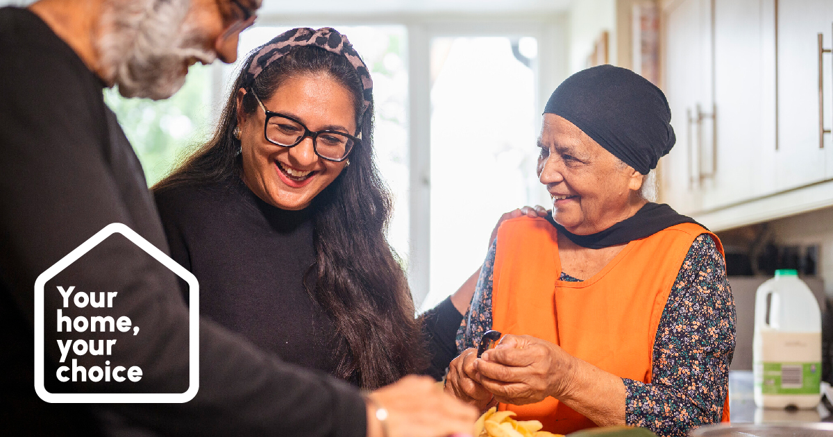 Photograph of two women and a man smiling and preparing food and the Your Home, Your Choice logo