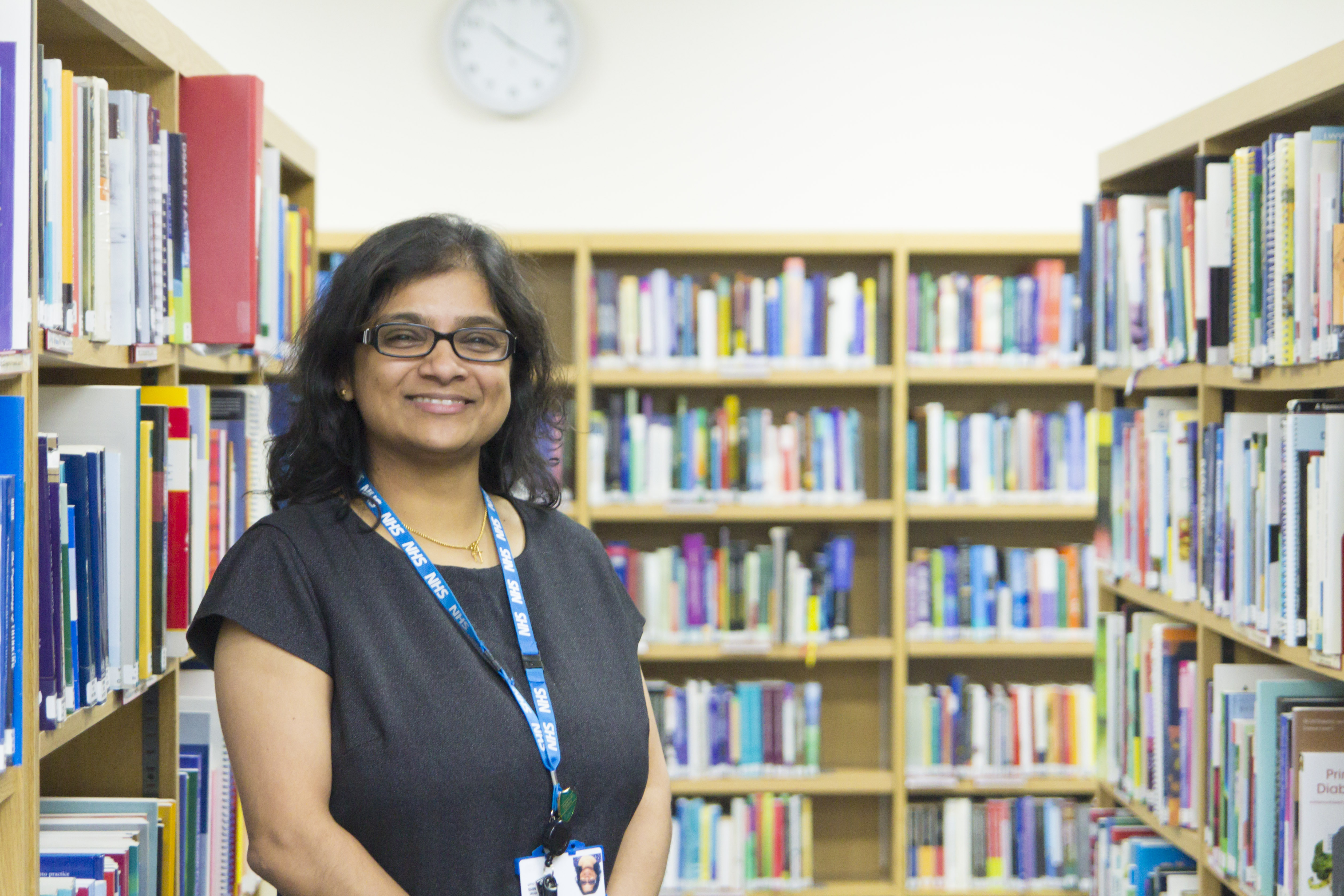 Staff libraian standing proud