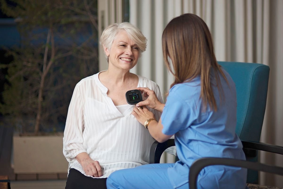 A nurse using a TytoPro device to carry out a heart exam