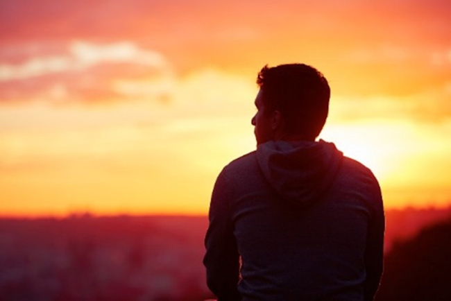 Contemplative-looking man at sunset