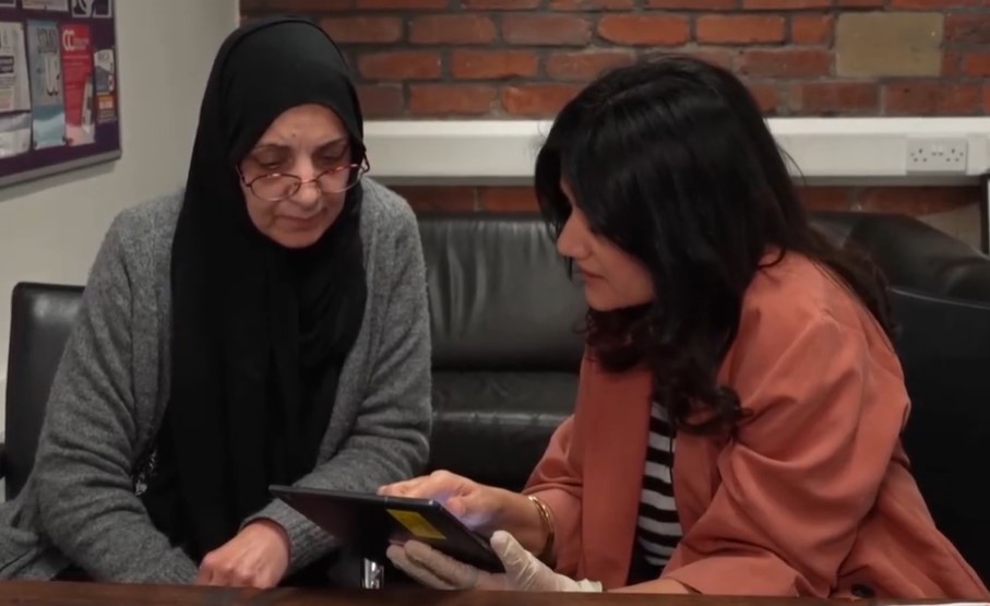 Noshina on the left discussing PocDoc test results with attendee 