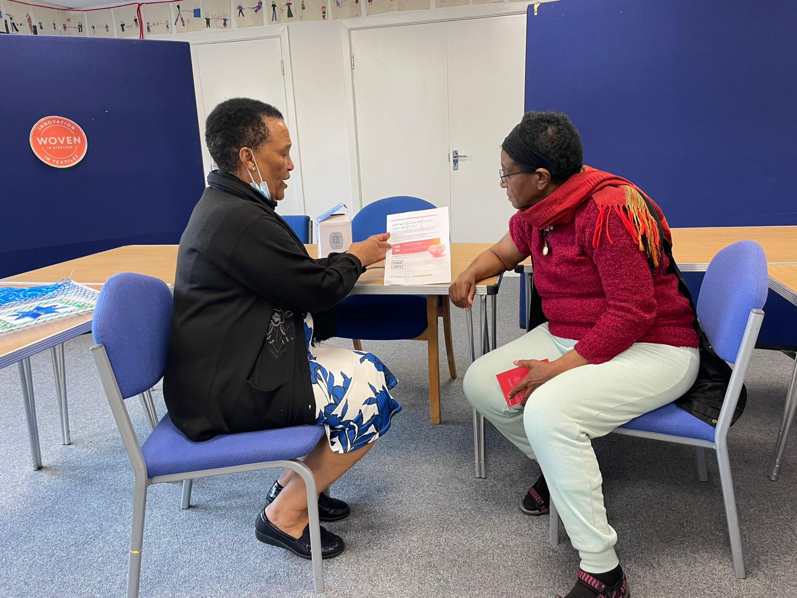 A community champion talking to an attendee