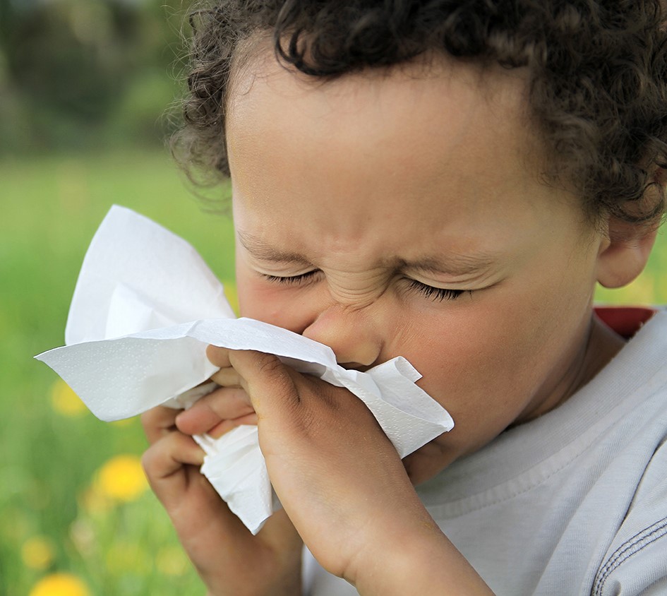 A young child sneezing