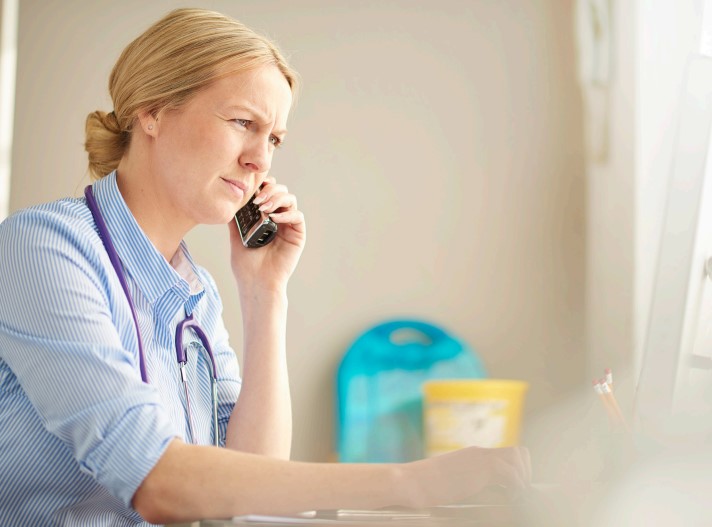 A doctor using a telephone